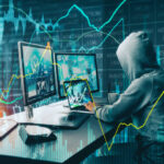 Side view of unrecognizable hacker at desktop using computers with forex chart on blurry office background. Malware and finance concept. Double exposure