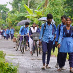 Students return home from school in the outskirts of Kolkata, India, on July 25, 2025. (Photo by Sudipta Das/NurPhoto via Getty Images)
