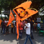 A member of The Bajrang Dal, the youth wing of the Vishva Hindu Parishad, is waving a flag featuring Hindu Lord Hanuman at a Shaurya Jagran Yatra event in Kolkata, India, on October 8, 2023. (Photo by Sudipta Das/NurPhoto via Getty Images)