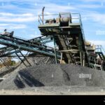 mobile-stone-crusher-machine-by-the-construction-site-or-mining-quarry-for-crushing-old-concrete-slabs-into-gravel-and-subsequent-cement-production-2HEP7BF