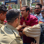 Indian policemen stop leaders and supporters of the People's Democratic Party (PDP) during a protest against the National Conference (NC)-led government in Srinagar, Jammu and Kashmir, on June 23, 2026. The demonstration addresses concerns over the alleged outsourcing of government jobs and recruitment irregularities. The PDP claims the government is bypassing regular recruitment procedures, lacking transparency in hiring, and undermining merit-based employment opportunities for unemployed youth. Official estimates indicate that Jammu and Kashmir has one of the highest unemployment rates among Indian states and union territories, with youth unemployment being a significant concern. (Photo by Firdous Nazir/NurPhoto via Getty Images)
