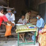 Burdwan Town, West Bengal / India - 02.05.2020: People in a queue to collect food grains at a ration shop in Burdwan town during the lock down period due to Novel Coronavirus (COVID-19) outbreak. At Burdwan Town, Purba Bardhaman District, West Bengal, India.
