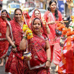 Hindu devotees walk along a road as they take part in a religious procession during the sacred month of 'Shravan' dedicated to Hindu God Shiva in Bengaluru on August 23, 2026. (Photo by Idrees MOHAMMED / AFP via Getty Images)