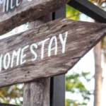 wooden-sign-says-homestay-means-260nw-1616315851
