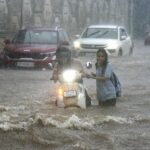 People-crossing-the-rain-water-filled-national-hig_1756895341962_1756895922697